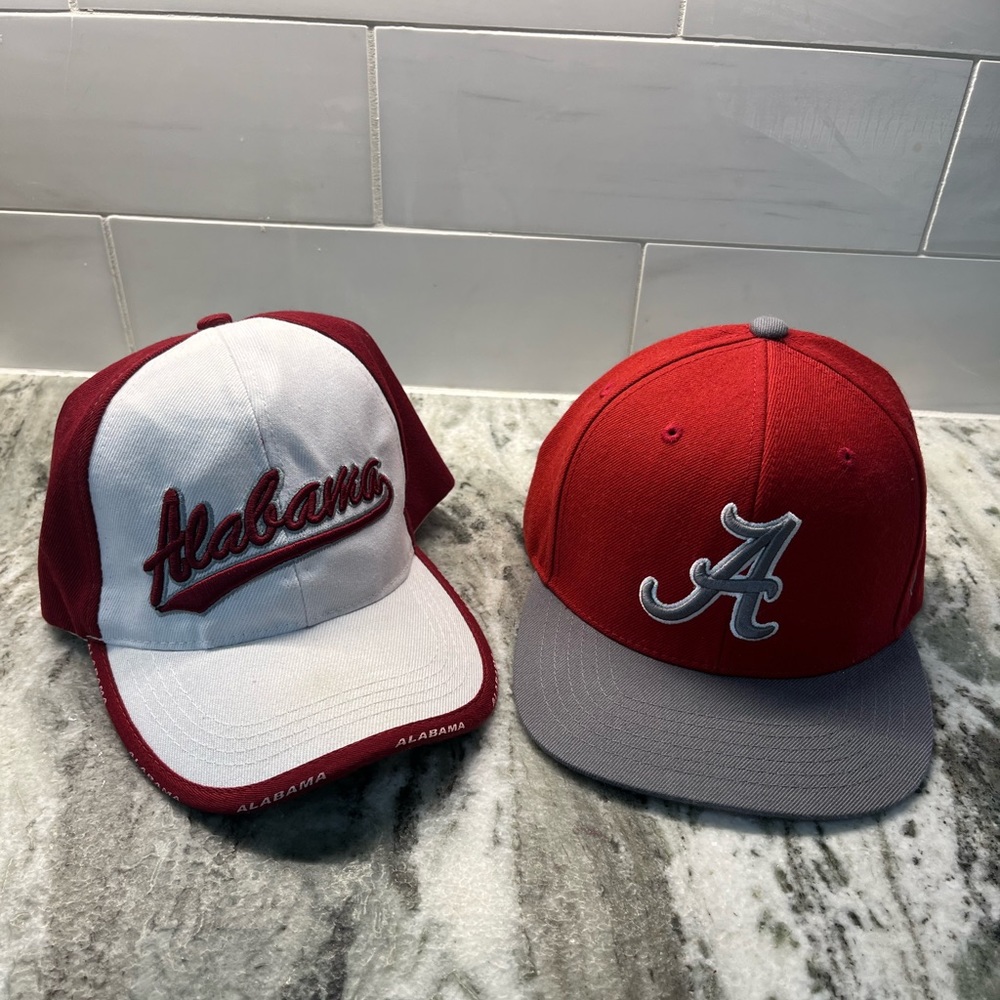 Two Men’s Alabama hats one in gray and Red the other in white and red.One size.